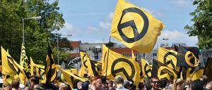 Anhänger der rechtsextremen Identitären Bewegung stehen in Berlin mit Fahnen auf der Brunnenstraße. 