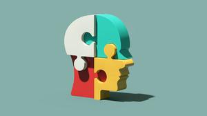 Verschiedenfarbige Puzzlesteine bilden einen dreidimensionalen menschlichen Kopf.